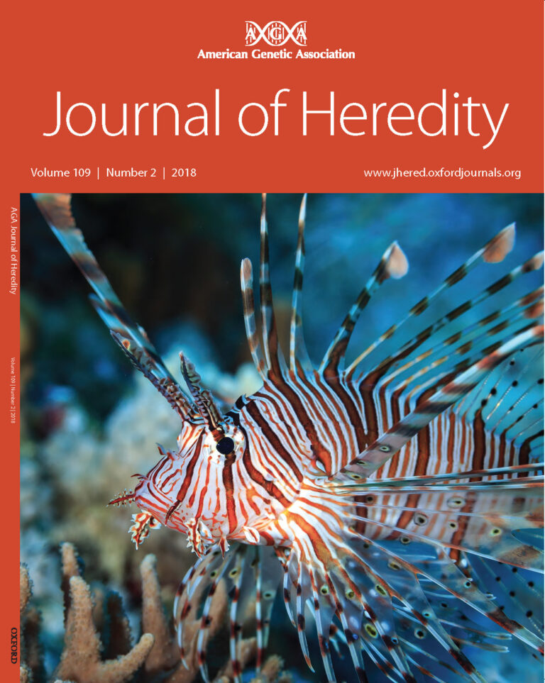 A lionfish swims near coral, featured on the cover of the Journal of Heredity, Volume 109, Number 2, 2018.